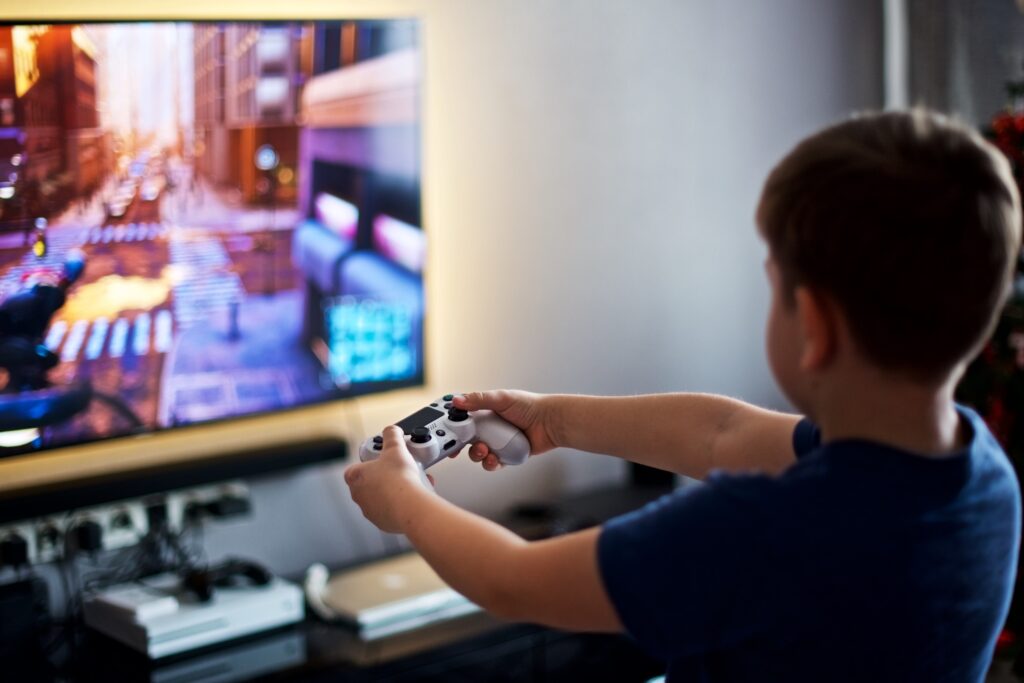 Boy with a joystick playing a computer game